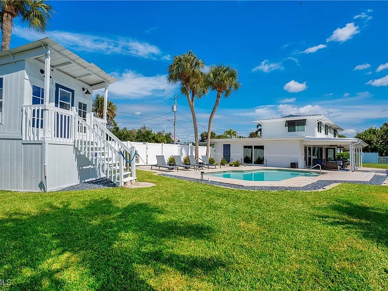 Backyard, pool and waterfront at OceanTimes, a monthly snowbird rental in Fort Myers