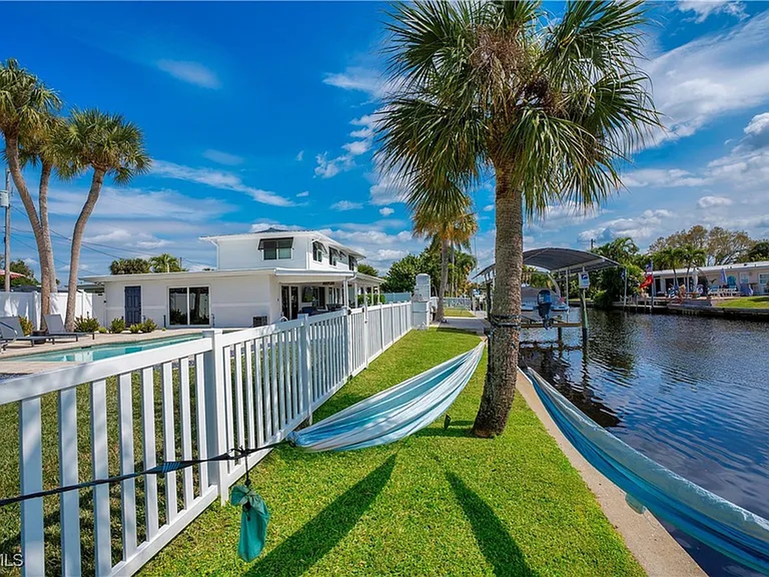 Waterfront lawn and canal at OceanTimes, a Fort Myers base for Gulf beach trips